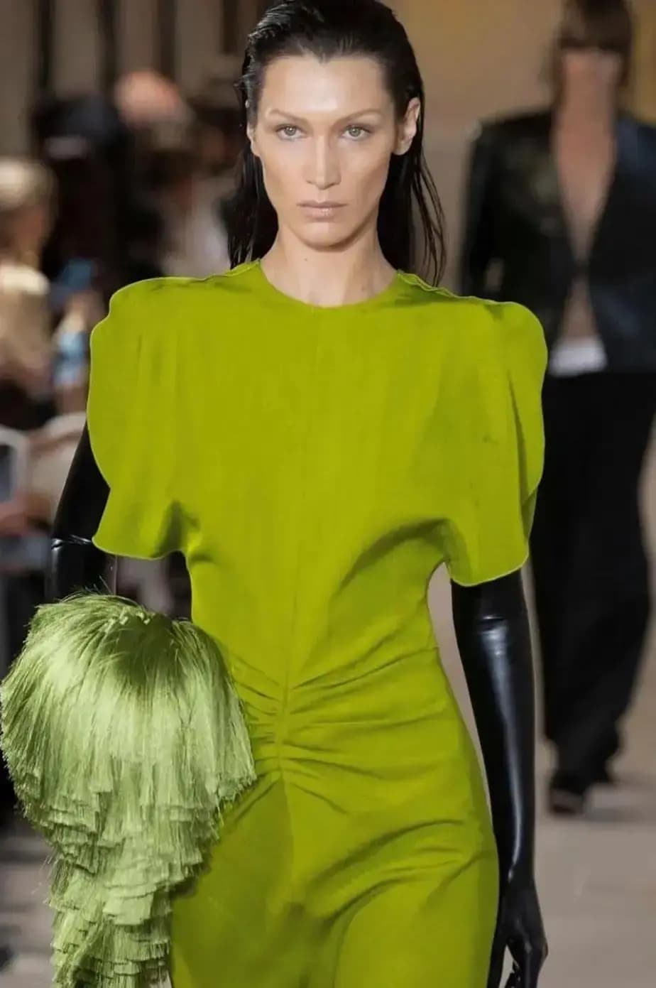 Woman in Green Dress with Straightened Black Hair Flipped Behind