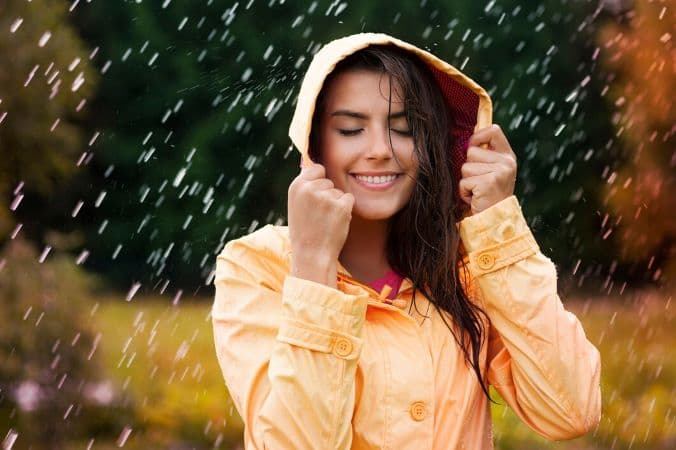 girl is wearing rain coat to protect her hair