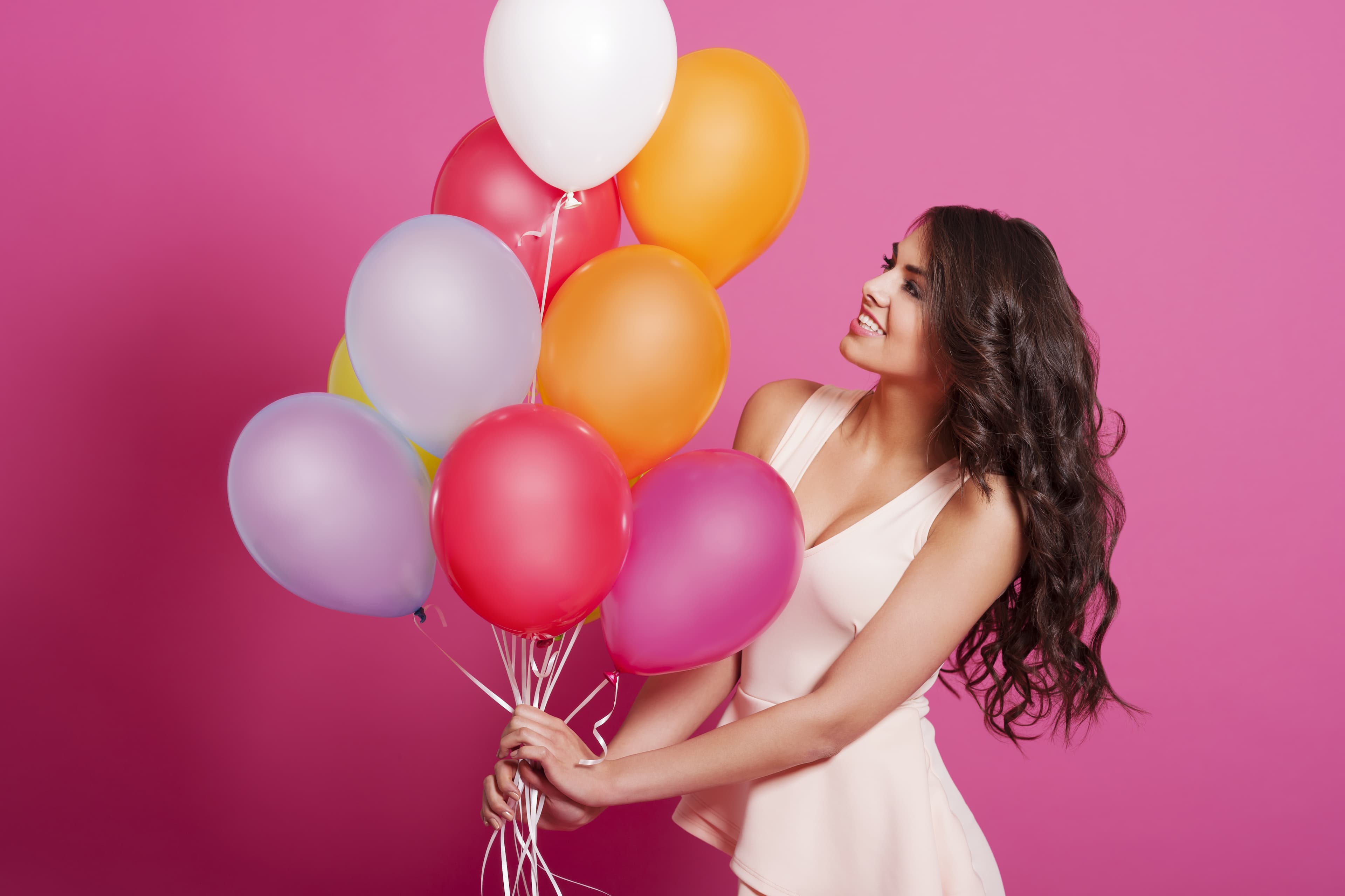 Girl holding balloons